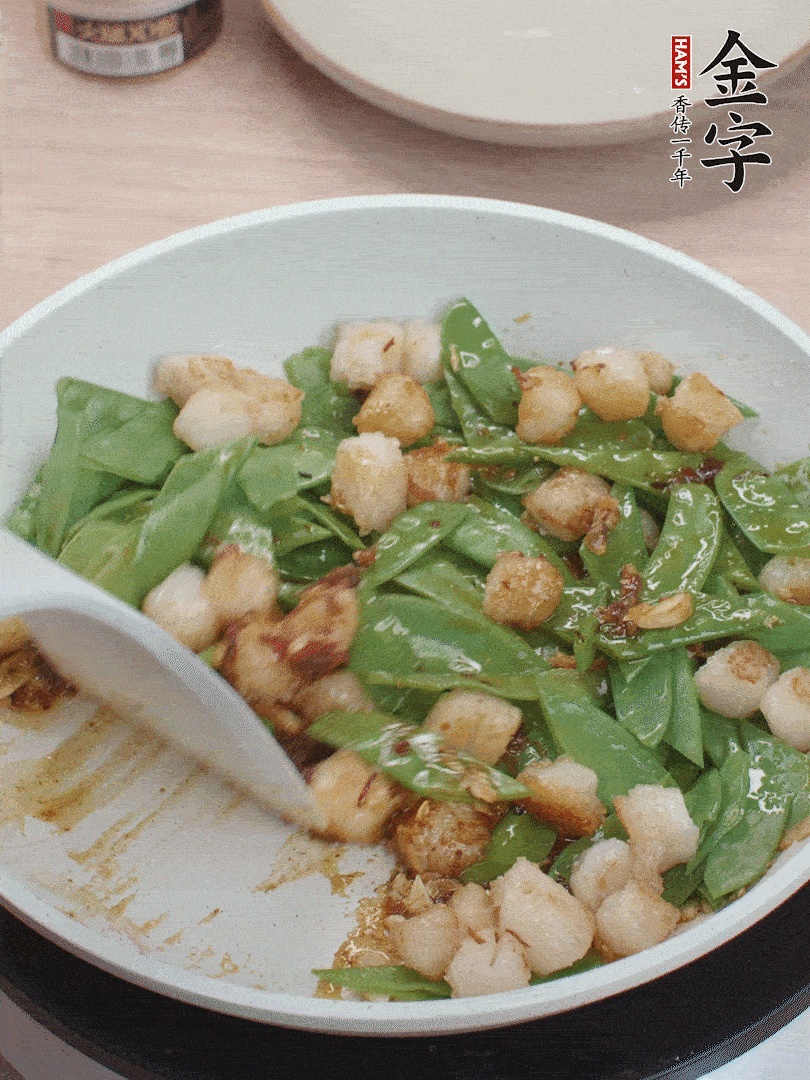 下甜豆莢、鮮貝輕輕翻炒均勻。
